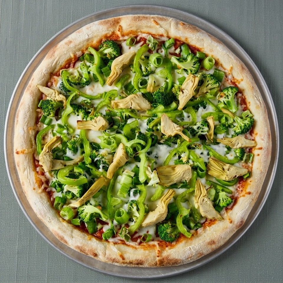 Vegetable pizza topped with broccoli, green peppers, artichoke hearts, scallions, melted cheese, and tomato sauce.
